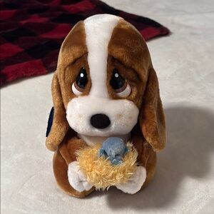 Sad Sam plush holding nest with blue bird.